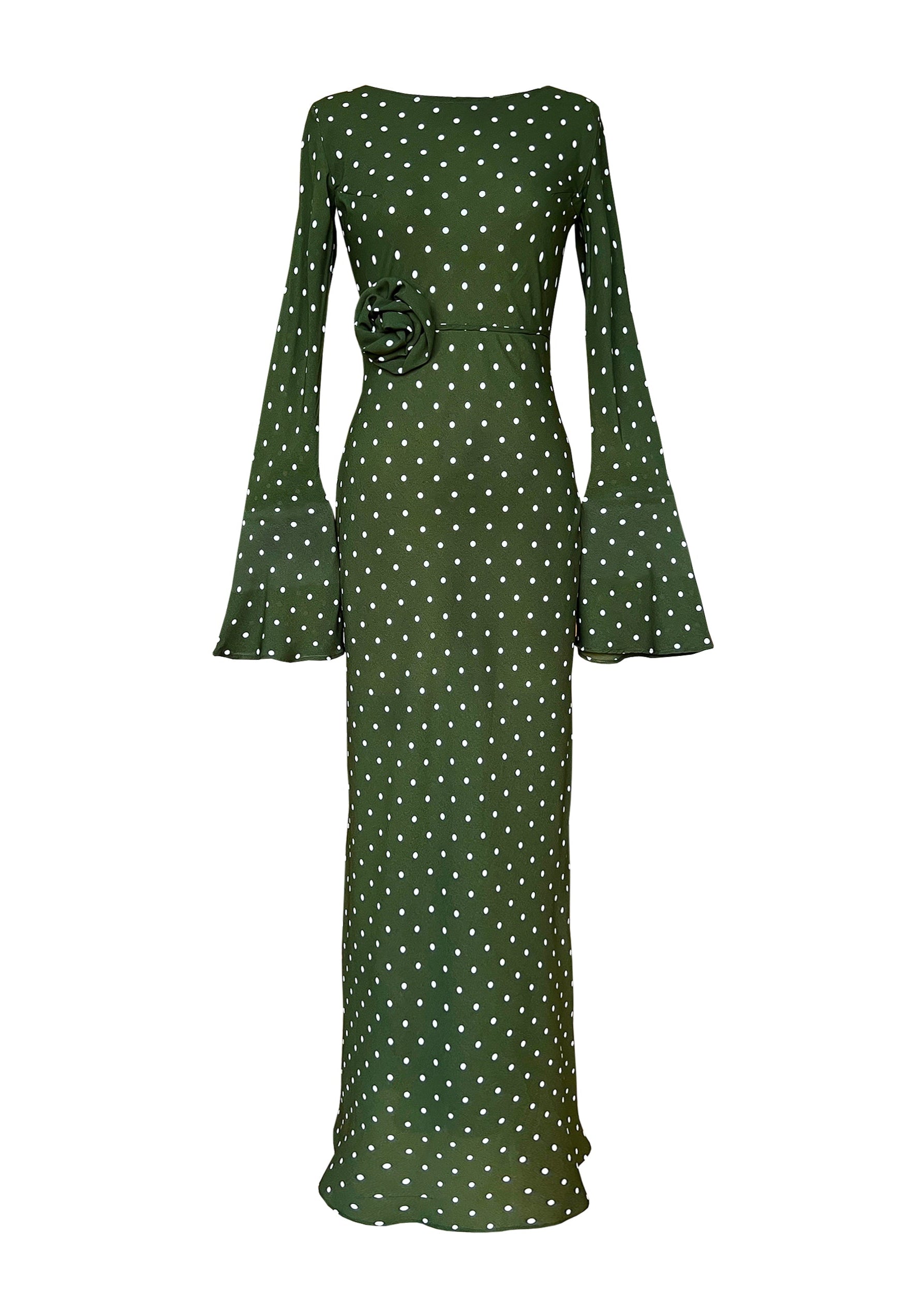 Green dress with white polka dots on a white background